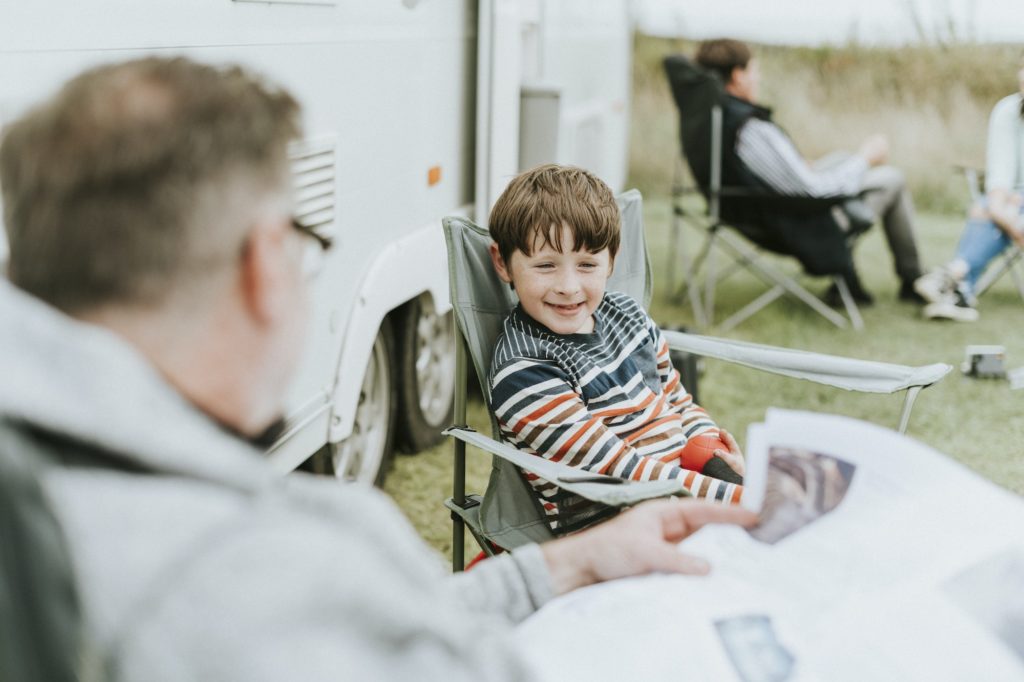 Happy young boy sitting with his grandfather